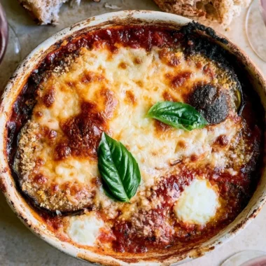 Delicious Eggplant Parmesan served with marinara sauce and melted cheese