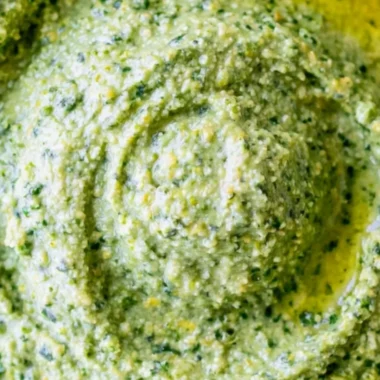 Nut-free pesto sauce made with fresh basil and olive oil for a healthy twist.