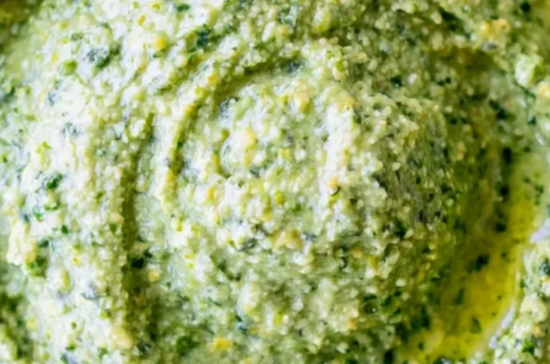 Nut-free pesto sauce made with fresh basil and olive oil for a healthy twist.