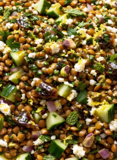 Cozy lentil salad with feta cheese, colorful vegetables, and herbs in a bowl.