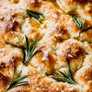 Freshly baked same day sourdough focaccia bread on a wooden cutting board