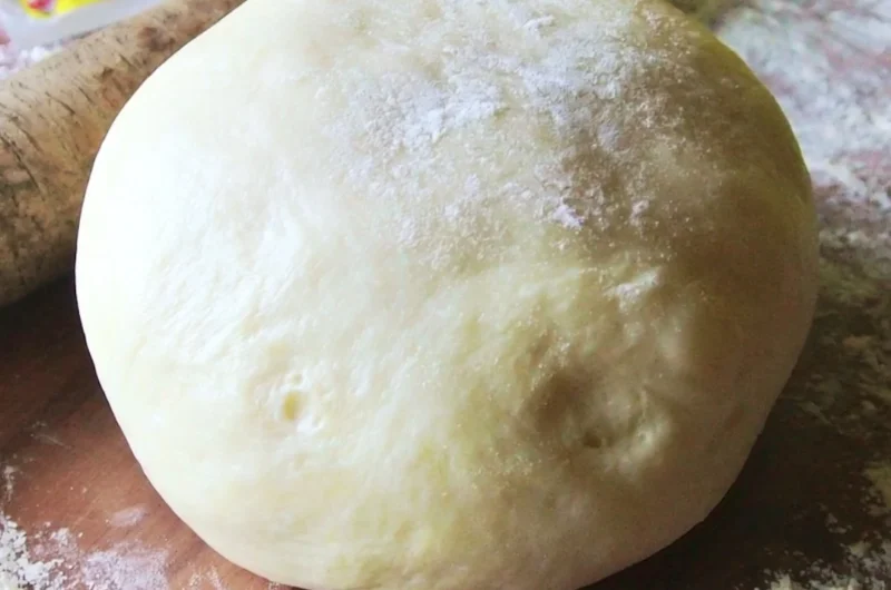A close-up of a freshly made Italian pizza dough ready for toppings.