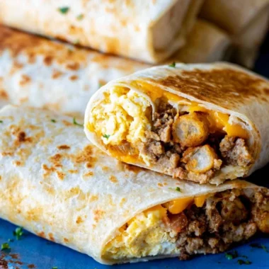 A tray of make-ahead breakfast burritos ready to serve a crowd.
