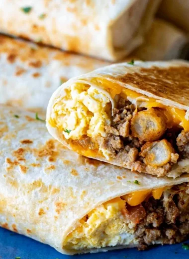 A tray of make-ahead breakfast burritos ready to serve a crowd.