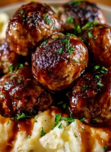 Cozy Salisbury steak meatballs with garlic herb mashed potatoes served on a plate.